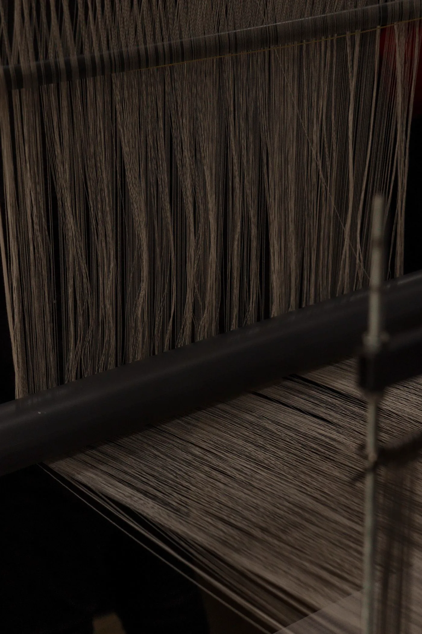 Yarn threads running through an industrial textile machine